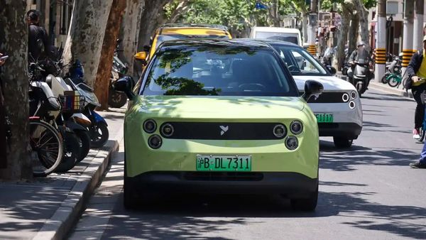 Green Nio Firefly driving along a city street